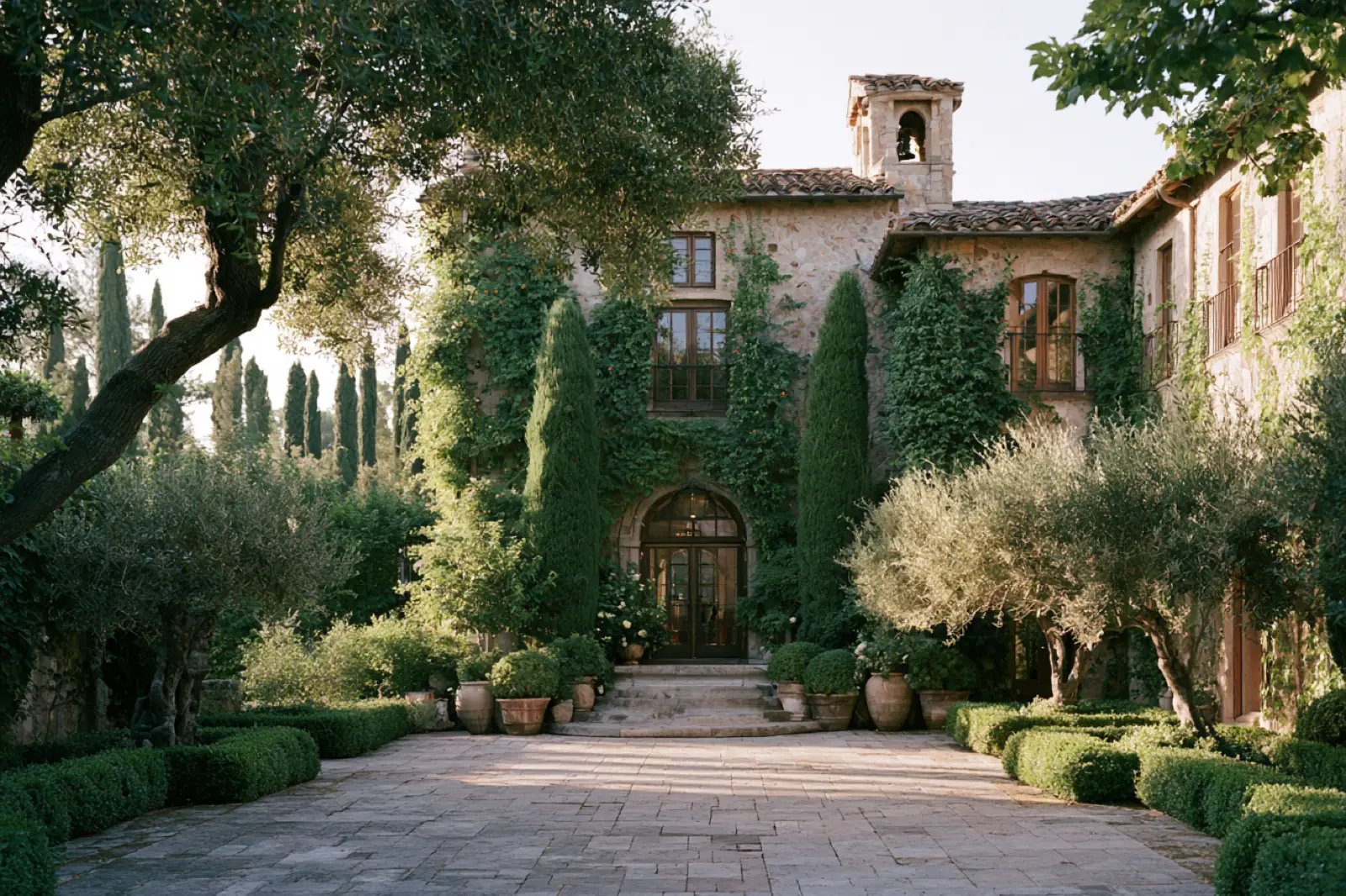 A villa covered in ivy at the end of a stone path