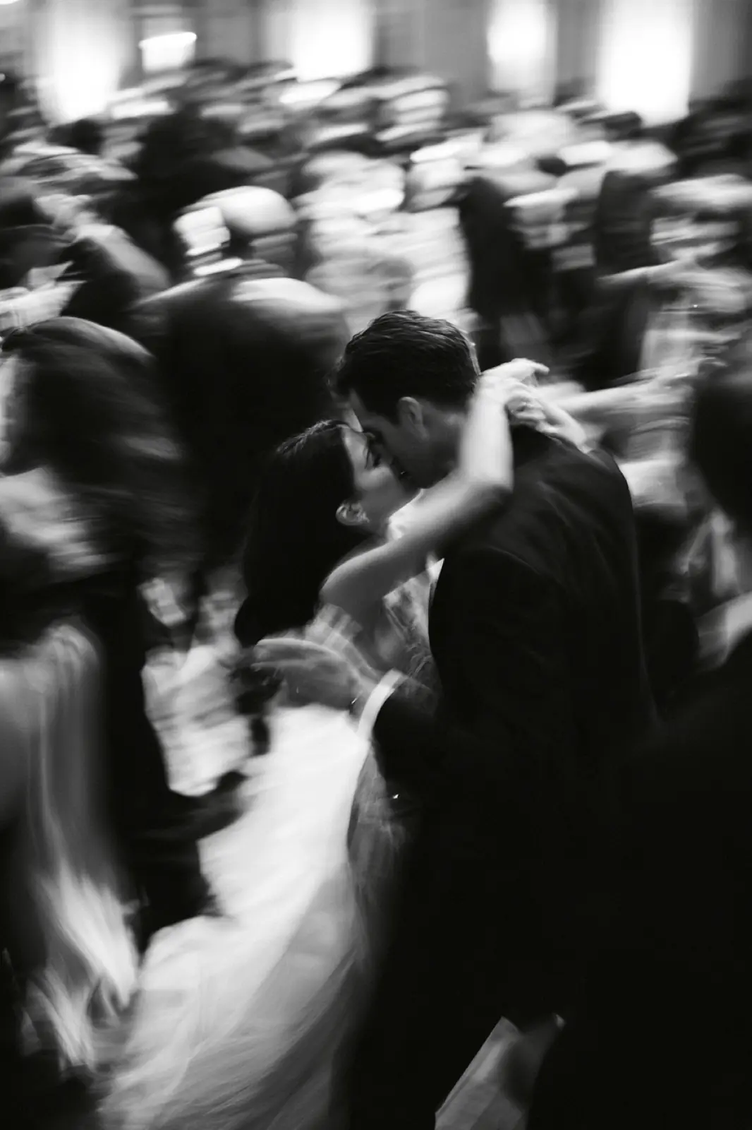 The dance floor, a blur of guests, in black and white