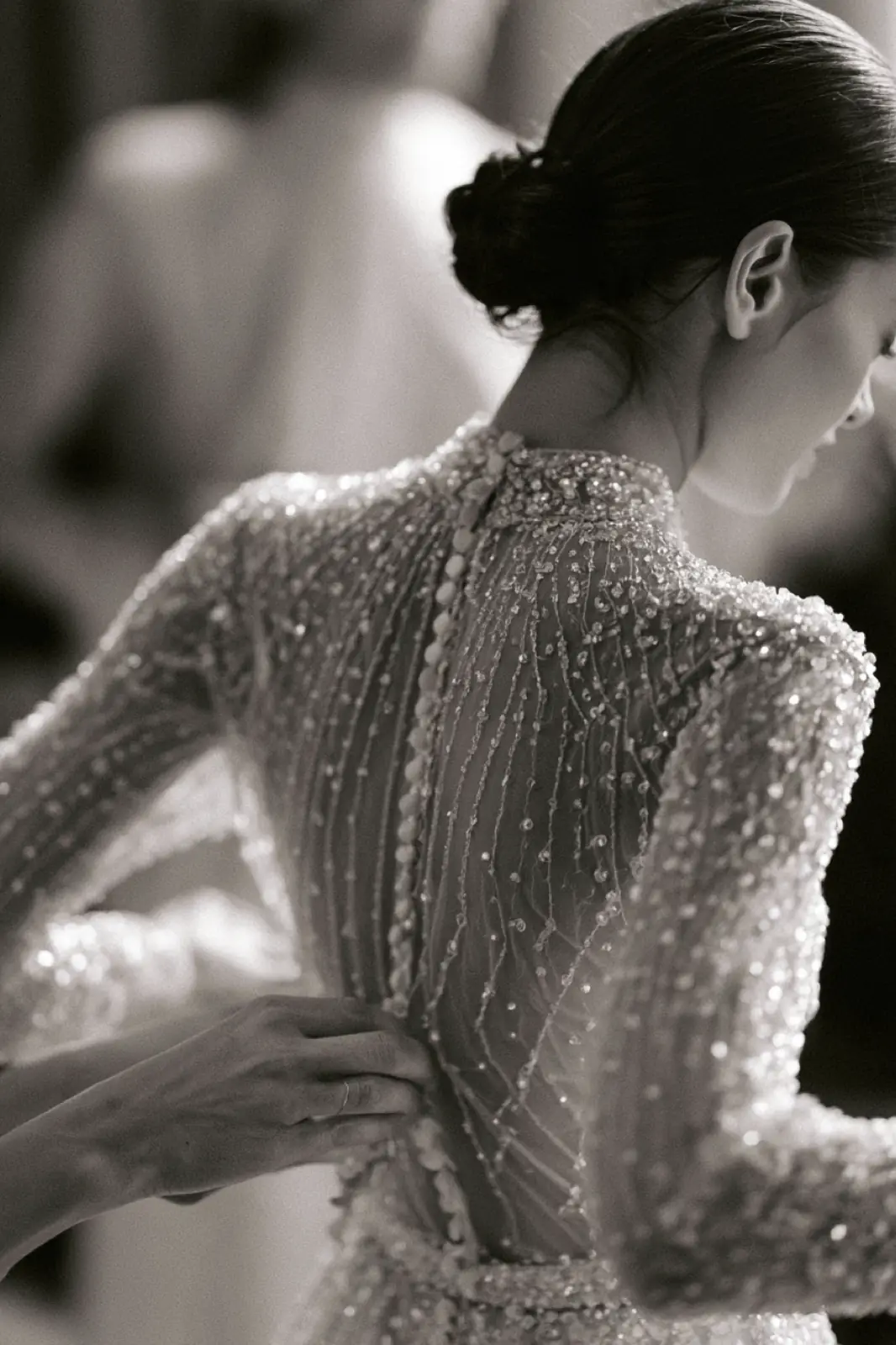 The back of a beaded lace wedding dress, in black and white