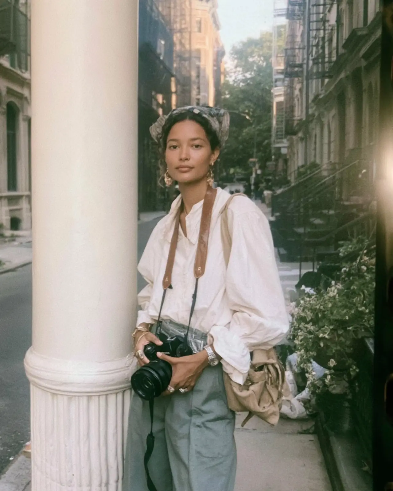 Ines, with a camera, on a street in Oslo
