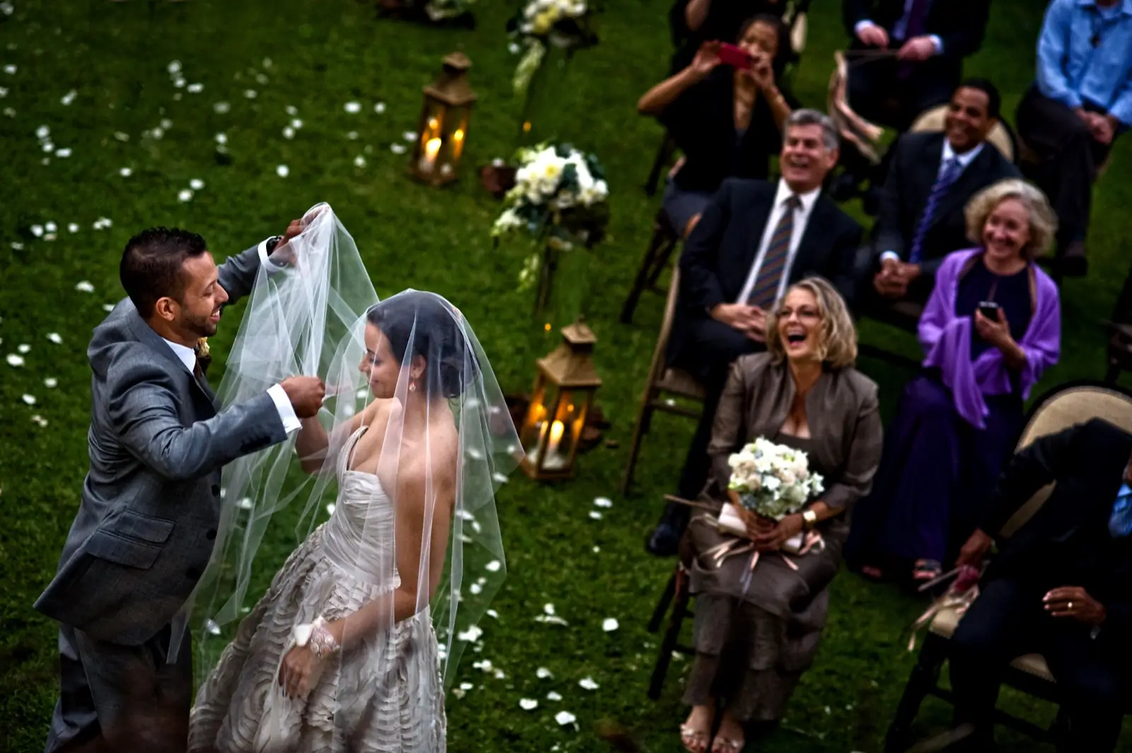 Confetti thrown over a couple on a lawn