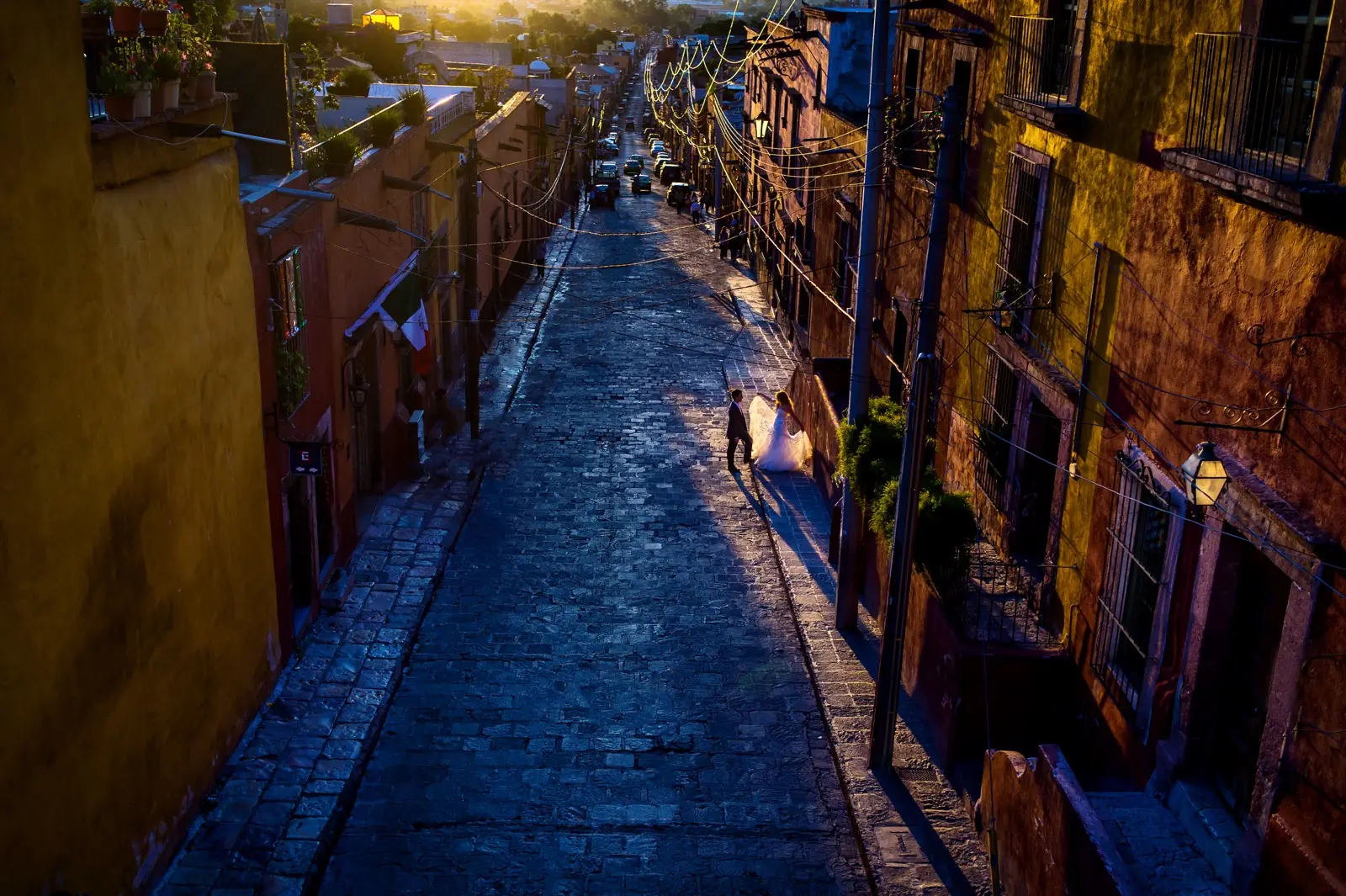 A couple in a deep blue alleyway