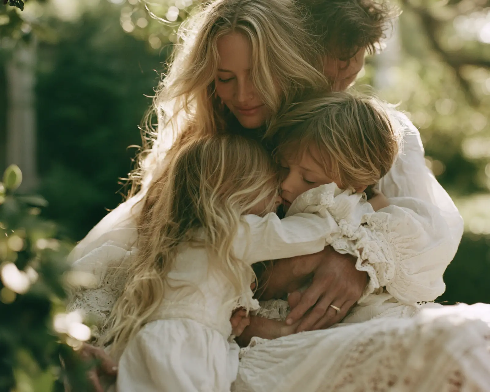 A mother holding her son close in the garden