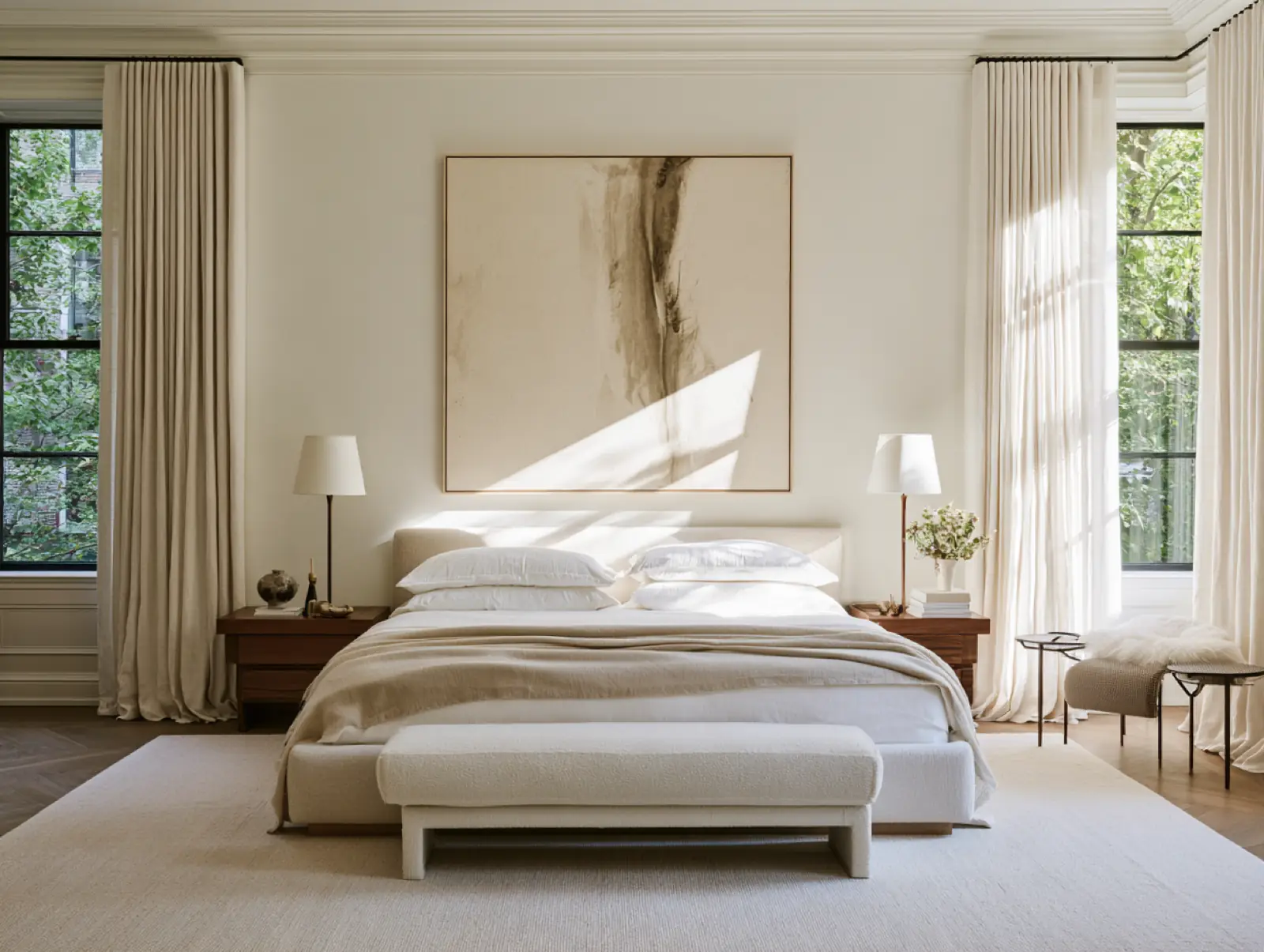 A quiet white bedroom in soft daylight