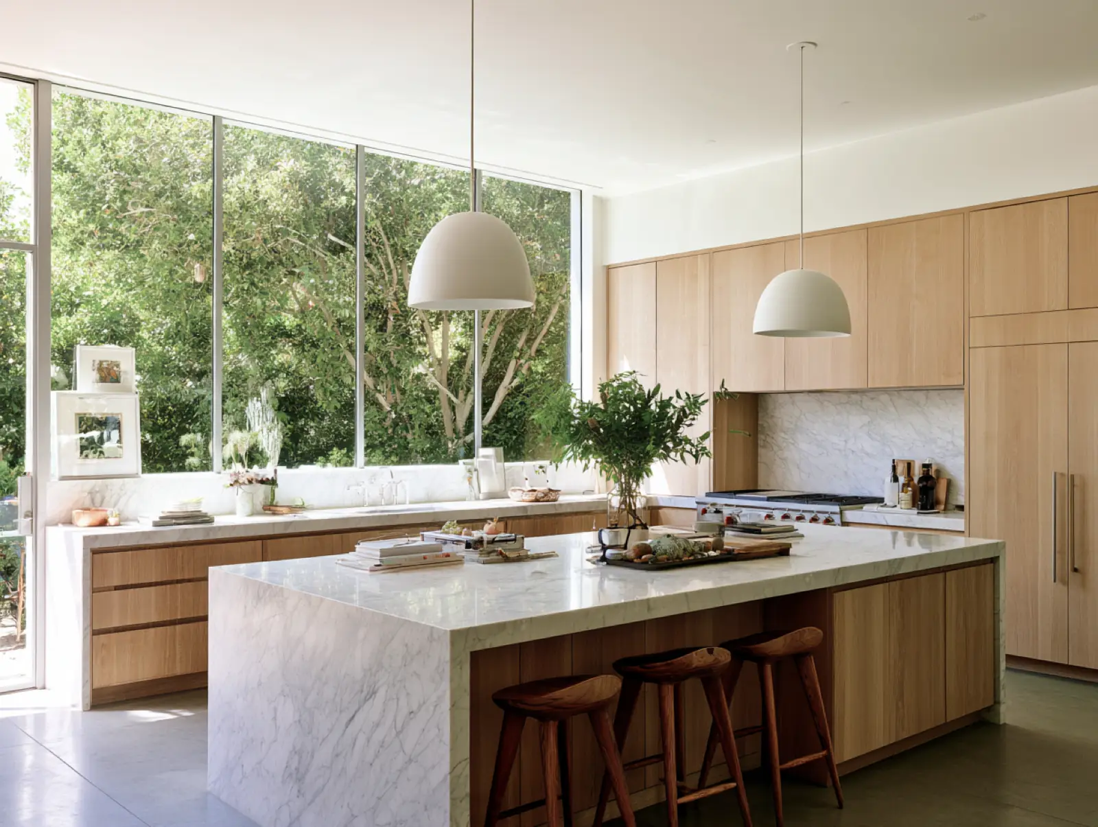 A kitchen island with stools in front of a garden window